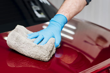 a picture of a hand waxing a vehicle