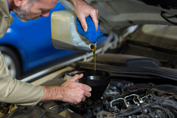 car-repair-maintenance-theme-mechanic-uniform-working-auto-service-pouring-motor-oil.jpg